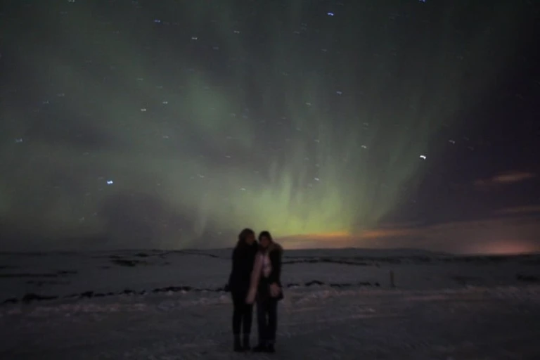 two girls against northern lights