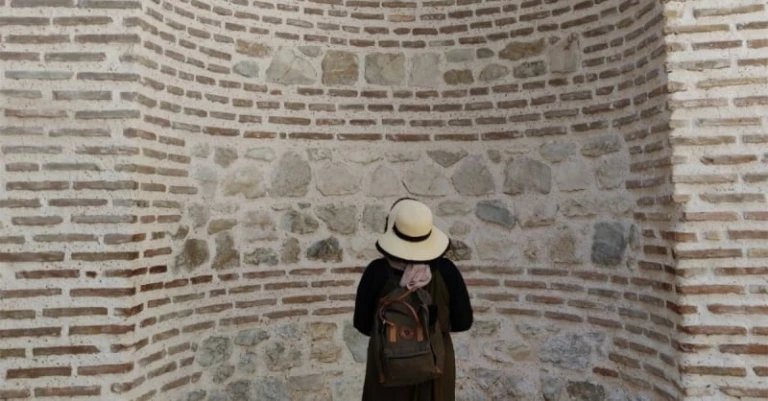 woman facing wall