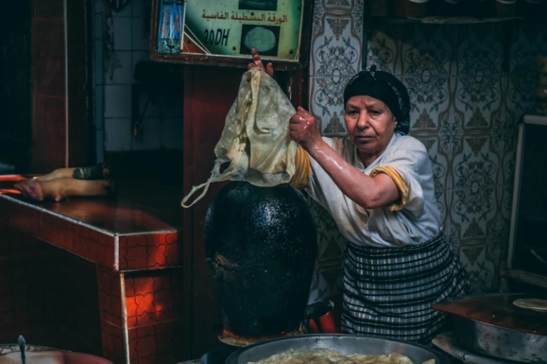 moroccan woman pouring ingredients
